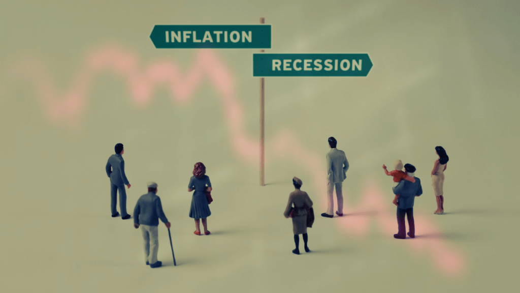People standing at a crossroads with signs pointing to “Inflation” and “Recession,” representing economic uncertainty